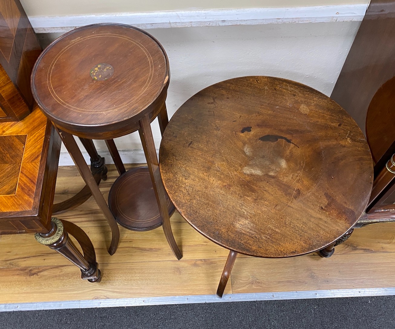 A George III mahogany circular tripod tea table, diameter 56cm, height 69cm together with a mahogany two tier plant stand